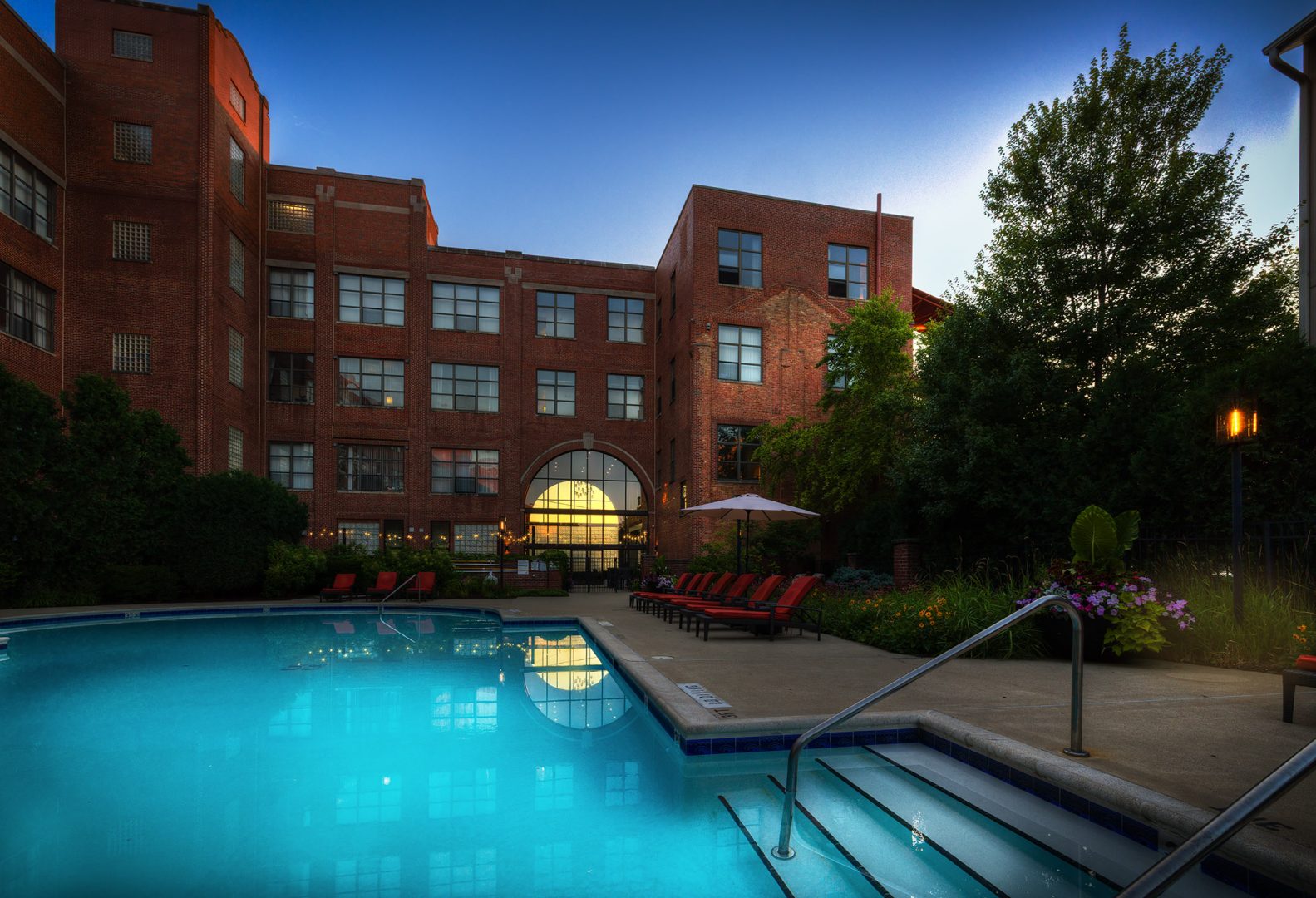 a large swimming pool with a balcony in front of it