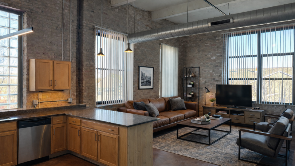 a living room filled with furniture and a large window
